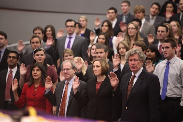 The new members take the initiation oath.