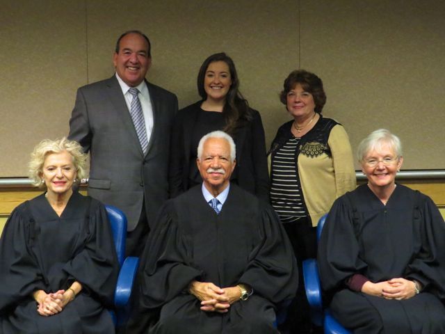 New admittee Kristin Creed and family with Justices Burke, Freeman and Theis.
