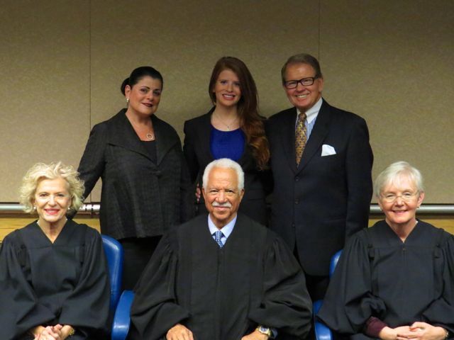 New admittee Grace Donovan (rear, center) and her family pose with Justices Anne Burke, Charles Freeman and Mary Jane Theis.
