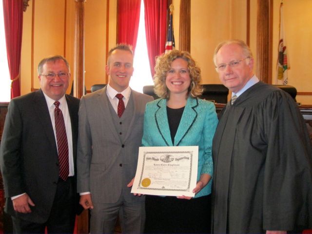 Father and ISBA member Randy Chaplinski, husband Mike Saineghi, new admittee L. Claire Chaplinski and Chief Justice Thomas L. Kilbride.