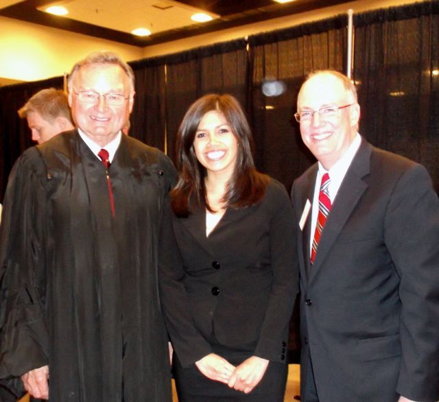 New admittee Juliane Rodriguez is congratulated by Illinois Supreme Court Justice Lloyd A. Karmeier and ISBA President John E. Thies.