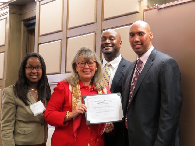 Event co-chairs Kenya Jenkins-Wright (left) and David Kadzai (second from right) and CCBA President John A. Fairman present ISBA President-elect Paula H. Holderman with a certificate honoring the ISBA for its sponsorship of the Law Day luncheon.