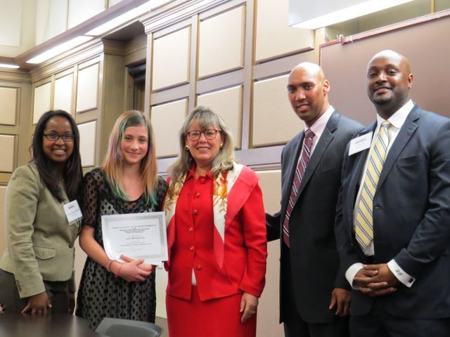 Event co-chairs Kenya Jenkins-Wright (left) and David Kadzai (right) with ISBA President-elect Paula H. Holderman, a student accepting the 2nd place prize on behalf of Iryna Motyashok of Skinner High School and CCBA President John A. Fairman.