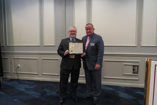 Curtis Ross, Presidential Commendations Award recipient,&nbsp;and President Russell Hartigan
