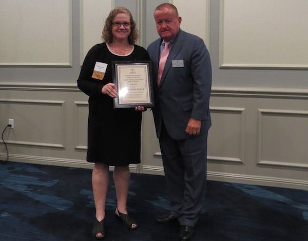 Kathryn Kelly, Austin Fleming Newsletter Editor Award recipient, and&nbsp;President Russell Hartigan
