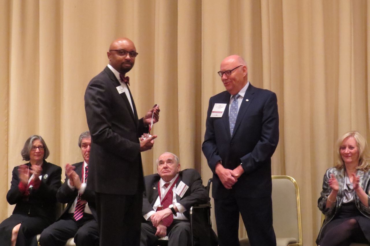 Vincent Cornelius presents James Holderman his award
