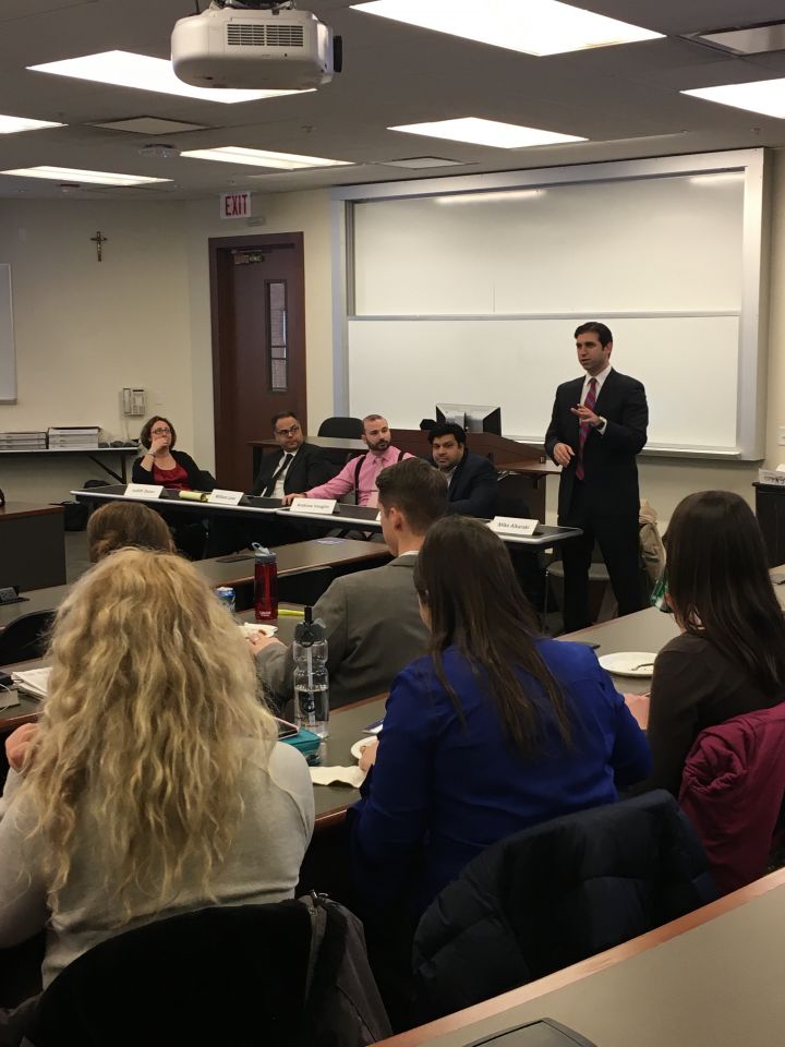 Moderator Mike Alkaraki and panelists speak to an audience of law students at&nbsp;ISBA Day at Loyola University Chicago School of Law.
