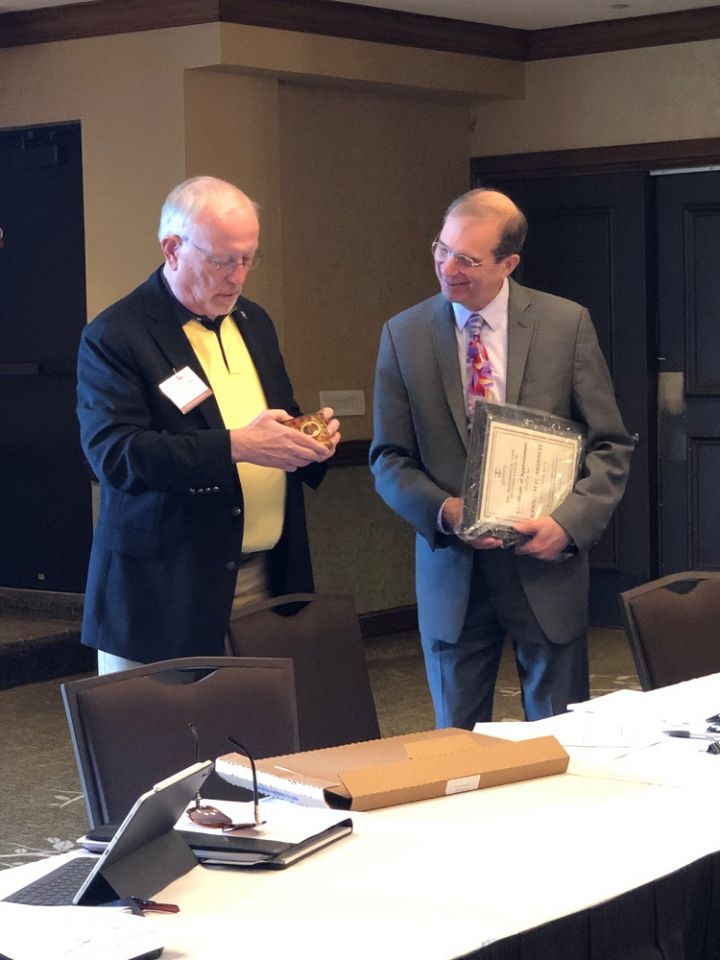 The Environmental Law Section Council's incoming chair Phil Van Ness presents a plaque to outgoing chair Kenneth Anspach. 