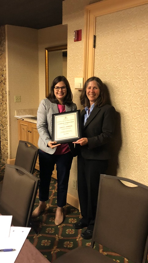 The Health Care Section Council's incoming chair Meghan O'Brien presents a plaque to ex-officio Janet Lerman. 