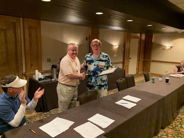 ISBA past president Russell Hartigan presents a plaque to the Tort Law Section Council's ex-officio Judge Tom Lyons. 