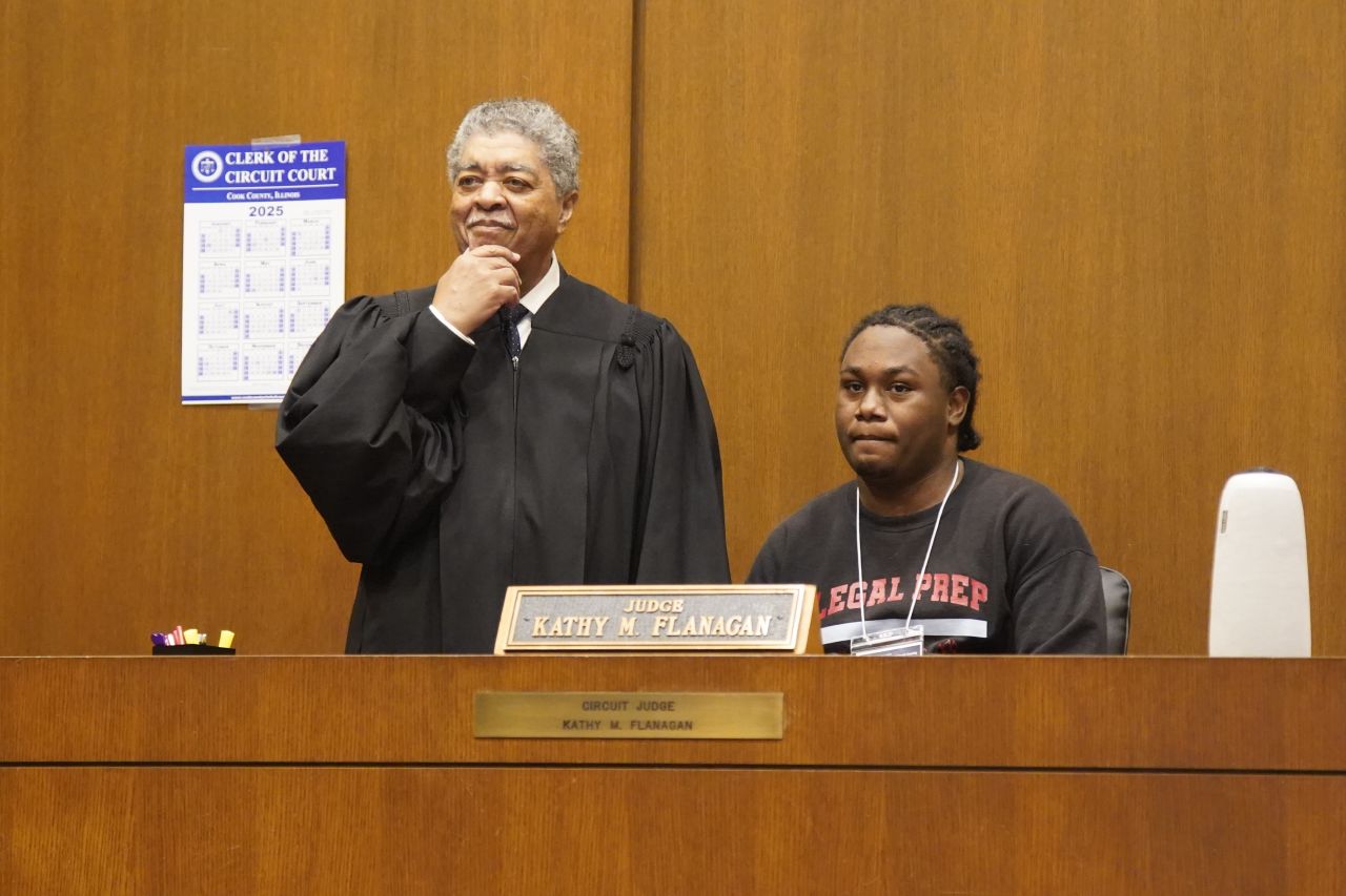Timothy C. Evans, Chief Judge of the Circuit Court of Cook County, with a student on the bench. 