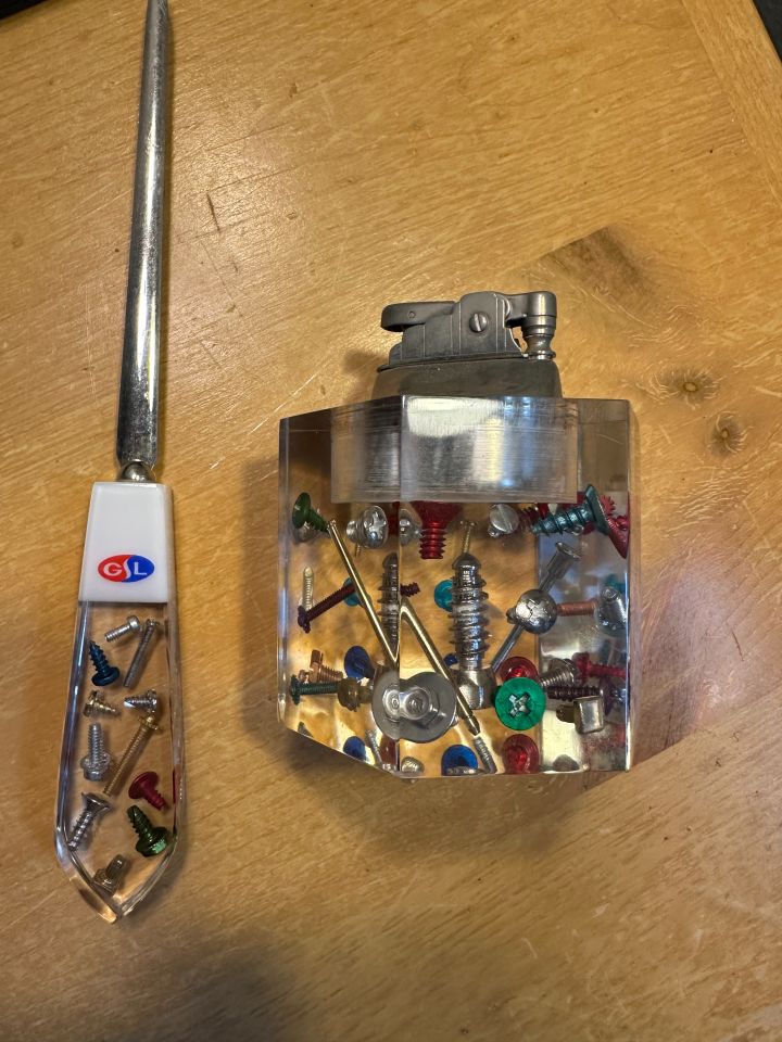 Christopher Barth: "My prized possession is a letter opener and cigarette lighter I inherited from my father, Robert. My dad was hired as an industrial engineer at Great Lake Screw Company who, as the name indicates, manufactured screws, bolts, nuts, etc. The Company gave my father these items when he was hired. As shown in the picture, the letter opener and lighter are made of a clear, Lucite material and have embedded in them screws, nuts, and bolts of many different colors. While the company closed many years ago, these items are an important reminder to me of my dad and, as a kid, held my fascination on many occasions as I marveled at how they made such each item."