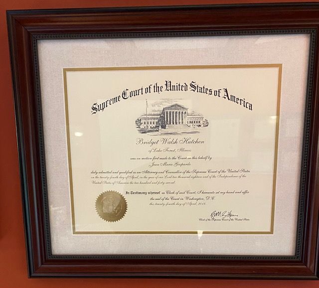Bridget Hutchen: "I have two related favorite items in my office. The first is my U.S. Supreme Court Admission Certificate from 2018 and the second is my Ruth Bader Ginsburg bobblehead! The admission to the U.S. Supreme Court is purely an honorarium with no practical impact on my practice, but it was a beautiful event sponsored by Loyola Law School. Justice Ginsburg was still alive and was sitting on the bench that day. I have always admired her, both personally and professionally. Much of her personal life mirrored my own personal experiences -- a wife, a mother, following her husband's career and transferring to a different city and law school. During Covid when we appeared via Zoom, I would position her bobbleheaad so that it was visible in the Zoom hearing!