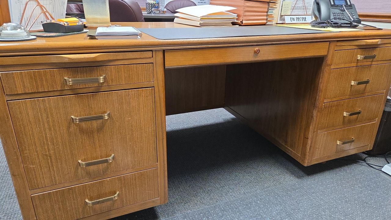 Jennifer Kincaid: "My prized possession isn't on my desk; it is my desk. My grandfather bought the desk in 1965, made by the Leopold Company in Burlington, IA. It came with him to his new venture in Arlington, IA, in the 70s and he sat at it until his retirement in the 80s when it became my father's desk. He gifted it to me in 2013 after I became a partner at my firm. I think the legacy of my grandfather and my father and all the hard work that has been done at this desk for over 60 years."
