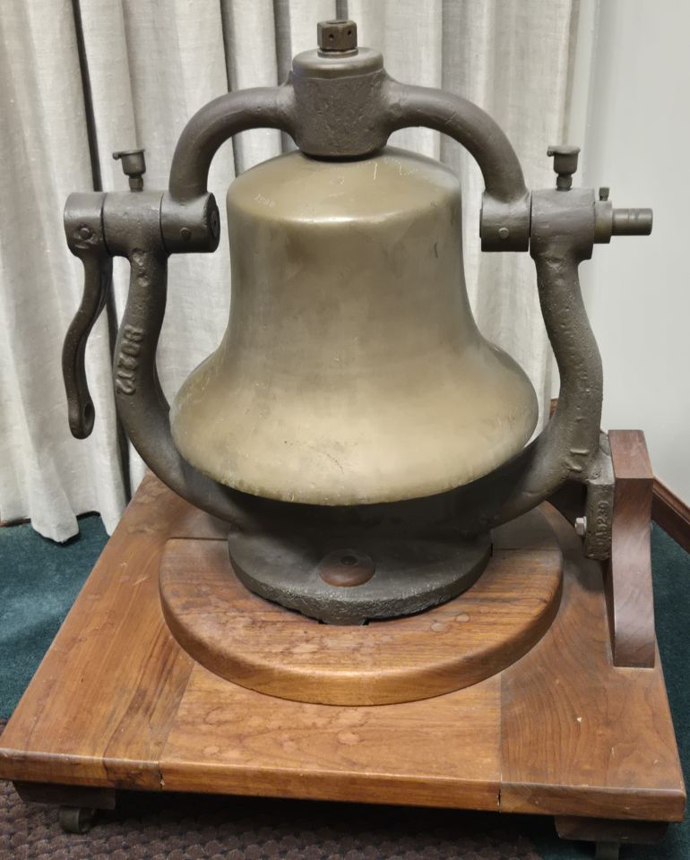 E. Phillips Knox: "Steam engine bell from the Illinois Central Railroad. A gift to my grandfather, Enos Phillips, Urbana attorney from 1925-1978, from the President of the Illinois Central Railroad. Cast in 1900, it is alleged to have been removed from the last steam locomotive retired from service by the ICR."