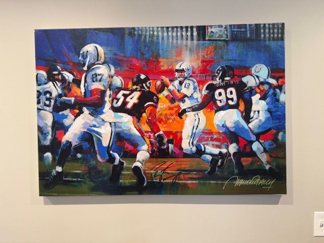 Heather Kroencke: "I love seeing this signed Peyton Manning painting on my office wall and remembering the Colts’ 2007 Superbowl win against the Bears! Back in 2014, I got into a heated bidding war at a charity function against an avid Bears fan for this painting. I ultimately won, but when my husband (also an avid Bears fan) realized what I was bringing home, he was depressed at having to relive this memory. Turns out, the man who had donated this item overheard his bemoaning and told us he could also get Brian Urlacher’s signature to ease the blow. And he did!"