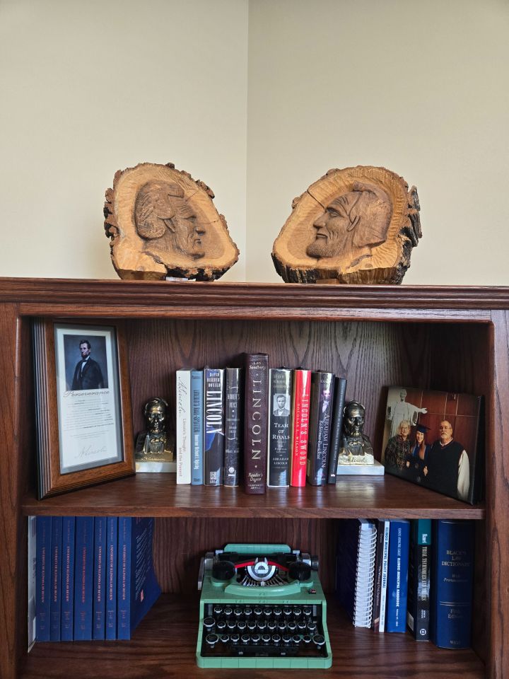 Hannah Lamore: "When I was an aspiring attorney, my late grandparents – Harold & Elaine Ryan – gifted me two carvings of Abraham Lincoln – one as a young man and the other as President – by Robert Fairbairn of Normal, IL, cut from an oak tree under which Abraham Lincoln gave a speech in Bloomington, IL. These carvings sit in my office above my Lincoln book collection. Practicing law in the presence of a tree Lincoln spoke under reminds me to be diligent, persevere and be honest like Abe."