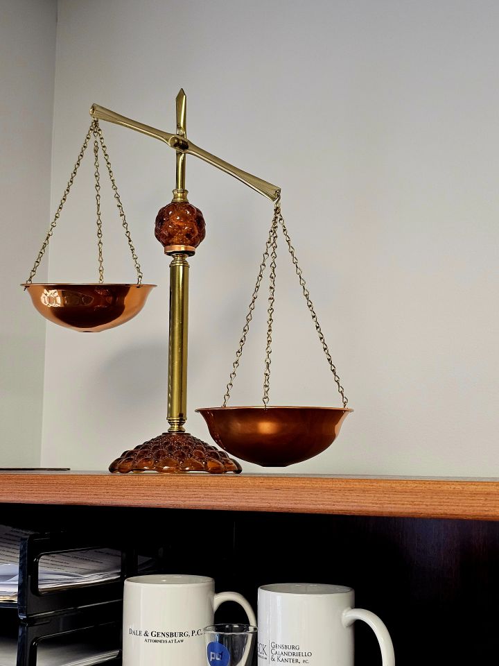 Sandra Mertens: "Attached is a photo of the scales of justice that were given to me many years ago as a law school graduation gift. The scales are a constant reminder that the legal system was designed to be fair and balanced. I keep the scales off-kilter to encourage myself to be such a good advocate that I "tip scales" in my client's favor."
