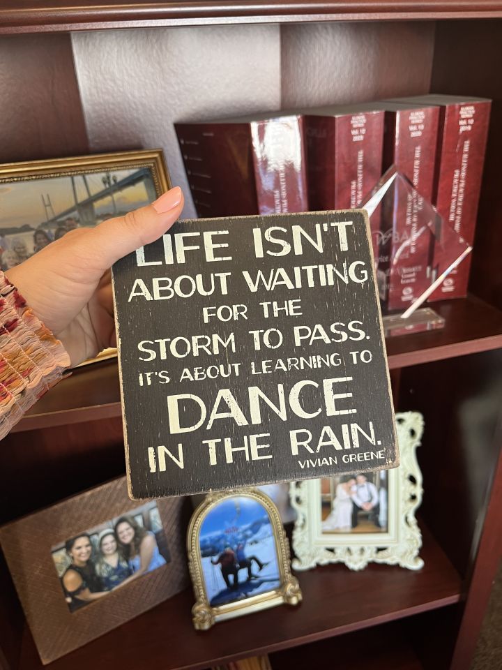 Genevieve Miller: "One of my most treasured possessions in my office is a sign that reads, 'Life isn't about waiting for the storm to pass, it's about learning to dance in the rain.' It's more than decor -- it's a daily reminder of resilience and finding joy in life's most difficult moments. Whether facing professional stress or personal trials, the sign grounds me with its quiet wisdom. It reminds me that growth often comes not from avoiding discomfort, but from learning how to move through it -- with grace, courage, and rhythm. A thoughtful secretary gifted it to me during a challenging time in my early career."