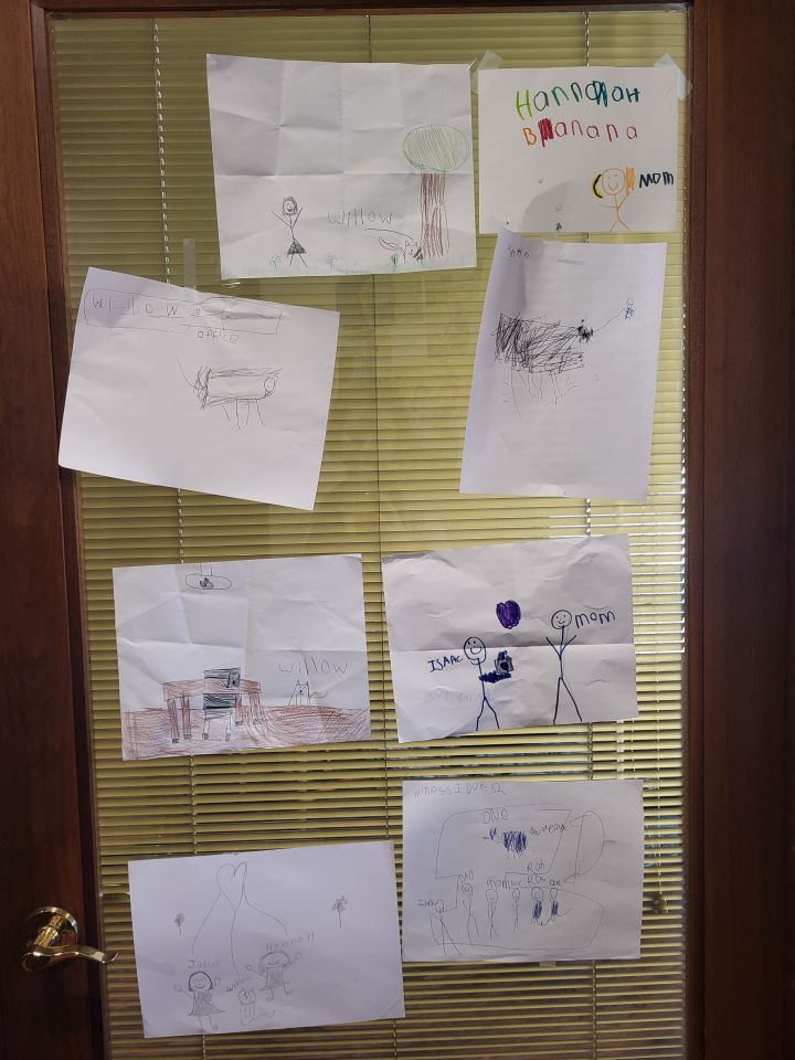 Hannah Wince: "My most prized possession in my office is the ever-changing art installation on my office door. It features artwork by my kids, Lily (8) and Isaac (6). Right now it mostly features portraits of our office cat, Willow, who is very popular with kids and clients."