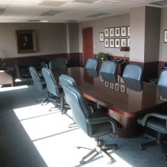 Main conference room with firm leaders (including Abraham Lincoln) pictured on wall