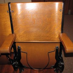 Close-up of seats with antique hat holder underneath