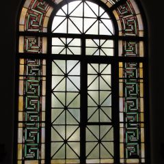 Stained-glass window behind judge's bench