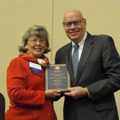 ISBA Board of Governors member Paula Holderman presents the Honorary Fellow Award to Chief Judge James Holderman.