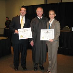 Husband and wife new admittees Michael Roush and Elizabeth Roush flank Justice Thomas L. Kilbride