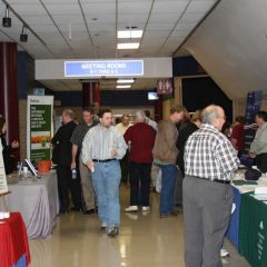Exhibitors showcase their services to attendees during a break between seminars.