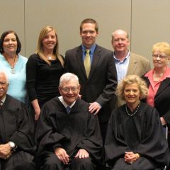 New admittee Connor Bidwill (rear, center) and his family with the justices.