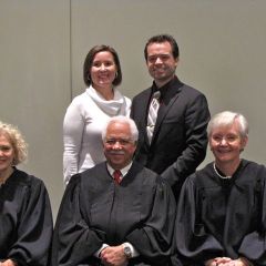 New admittee Conor LeFevour with a guest and the judges.