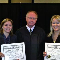 New admittee Shannon Stoffey, Chief Justice Thomas L. Kilbride and new admittee Jaimie Uphoff