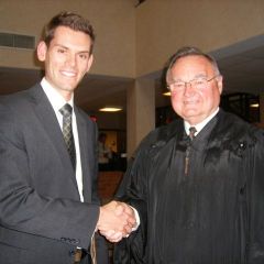 Justice Lloyd A. Karmeier congratulates new admittee Jason C. Dupont from Des Peres, Mo.