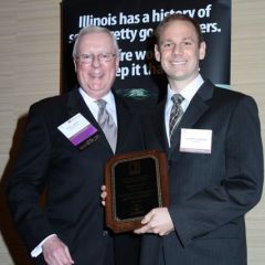 President O'Brien presents a Lincoln Legal Writing Award to Geoffrey T. Burkhart