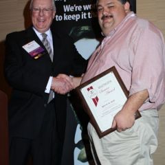 President O'Brien presents a 5-year Newsletter Service Award to Bryan M. Sims