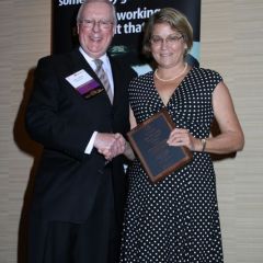 President O'Brien presents a 10-year Newsletter Service Award to Kathryn A. Kelly