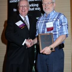 President O'Brien presents a 10-year Newsletter Service Award to Alfred M. Swanson