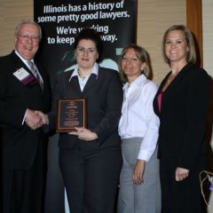 President O'Brien presents a John C. McAndrews Pro Bono Award to a team of lawyers from Caterpillar, Inc.