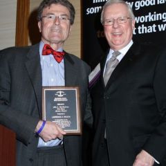 President O'Brien presents a John C. McAndrews Pro Bono Service Award to Lawrence Wojcik