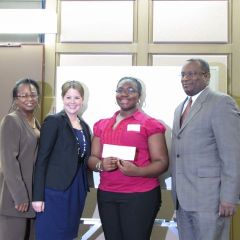 Angela Buford, Rebecca E. Cahan and Lawrence Hill present a $250 check to 1st place essay contest winner Taelar Chatman.