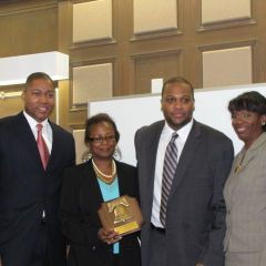 Buford and Perkins present an award to John Marshal Professor Sam Jones and John Marshall Black Law Students Association President Calvin Townsend.