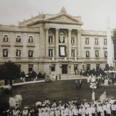 A celebration outside the courthouse following the end of World War I - notice the flags flying in each window.