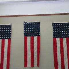 Three flags from the celebration still fly in the Circuit Clerk's office.