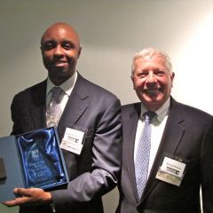 IBF President and charter member Vince Cornelius receives his charter member plaque from IBF Immediate Past President David Sosin.