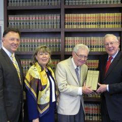 ISBA Immediate Past President John O'Brien presents "The Papers of Abraham Lincoln" to Chief Justice Thomas Fitzgerald as ISBA President-elect John Locallo (left) and ISBA 3rd Vice President Paula Holderman look on.