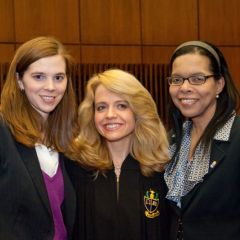 Chapter Justice Michele Jochner congratulates two new Phi Alpha Delta members and active ISBA members Laura Milnichuk (left) and Yolaine Dauphin.