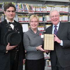 President O'Brien (right) presents the "The Papers of Abraham Lincoln" to Edwardsville Public Library Director Deanne Holshauser with the help of Lincoln re-creator Joe Woodard.