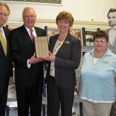 Illinois Supreme Court Justice Thomas Kilbride joins ISBA President John O'Brien in presenting the four-volume set to Galesburg Public Library Director Pam Van Kirk and archivist Patty Mosher.