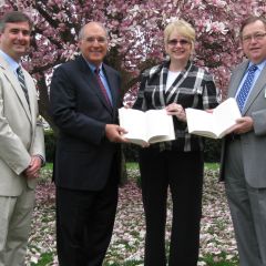 ISBA President-elect Mark Hassakis (second from left) presented The Papers of Abraham Lincoln to the Collinsville Public Library on April 5. Accepting the books is Barbara Rhodes (second from right), library director. On hand for the presentation were Chris Bauer of Greenville (left), chair of the ISBA